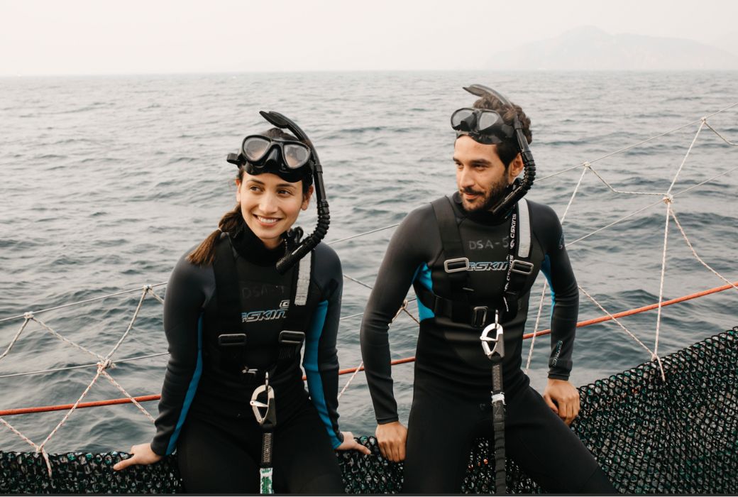twp snorkelers sitting on boat