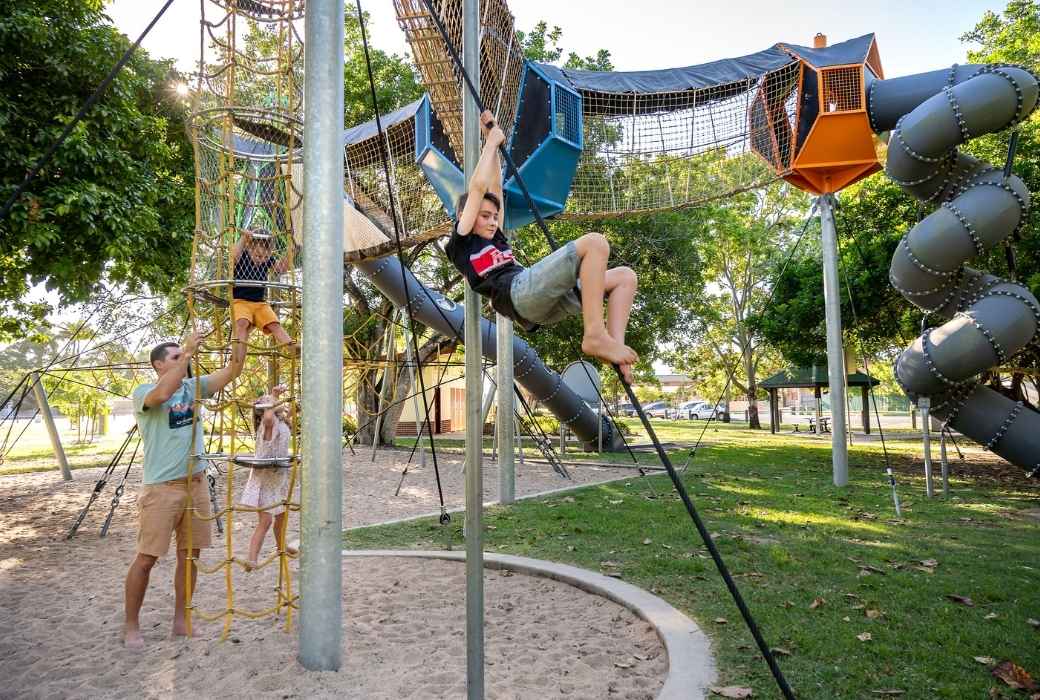 Kids playing on the playground in Queens Park