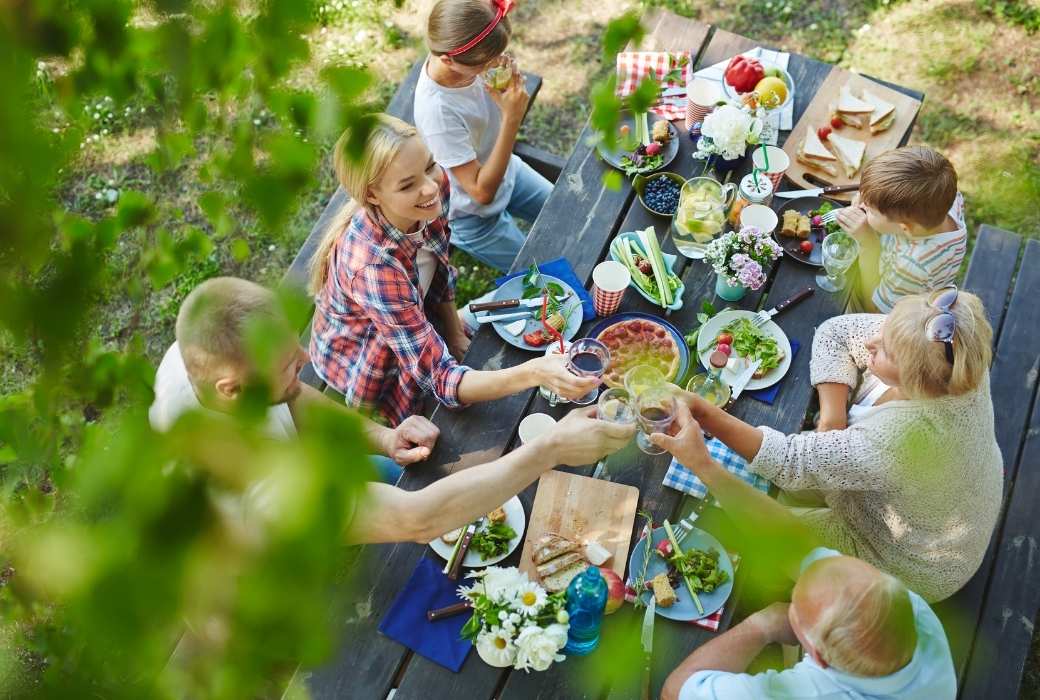 family having dinner on a picnic table