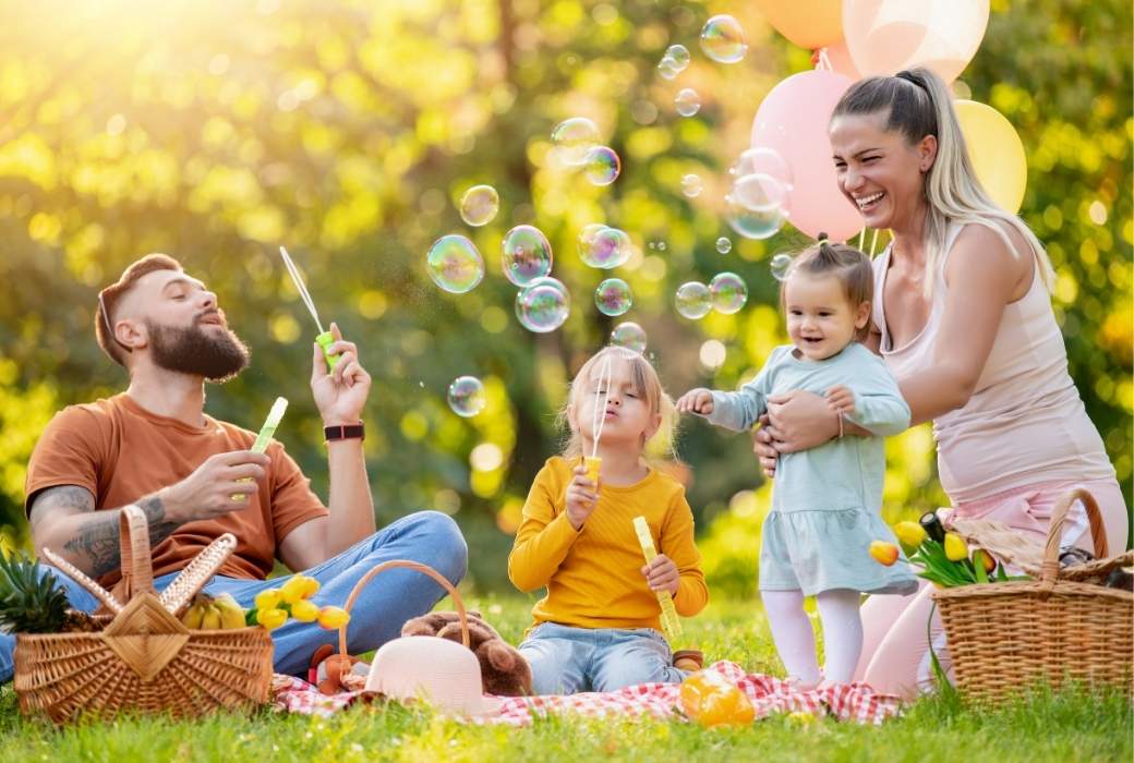 family having a picnic blowing bubbles