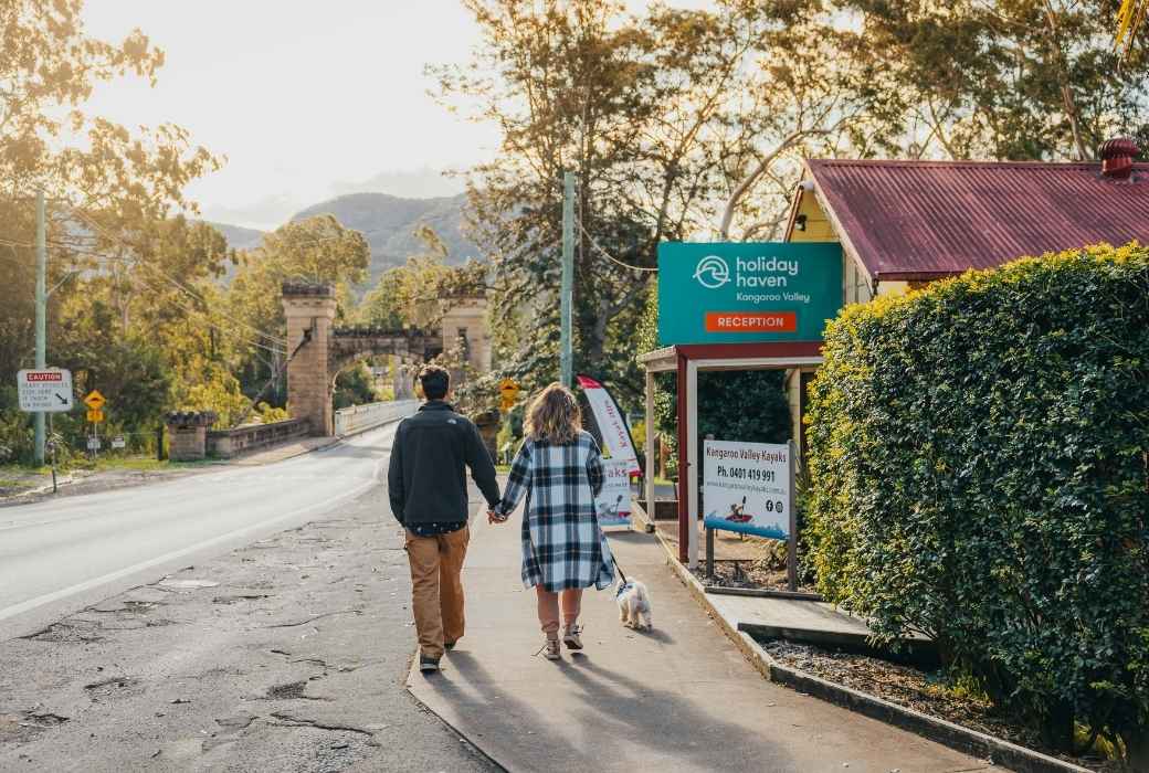 couple walking down a street Holiday Haven dog-friendly Holiday Parks in NSW